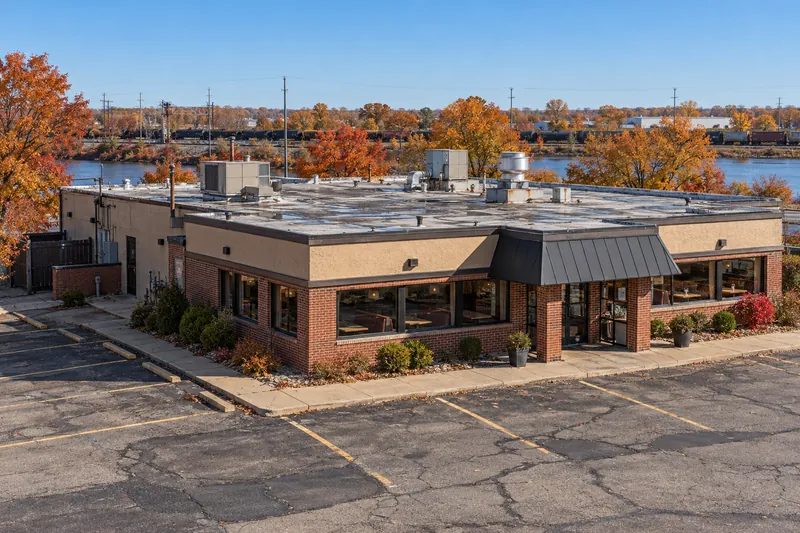 Brick commercial building with a low-slope roof behind mansard trim